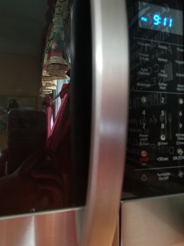 a black microwave with bump dots on numbers 1, 3 and 0 and the start and stop buttons. The dots are clear