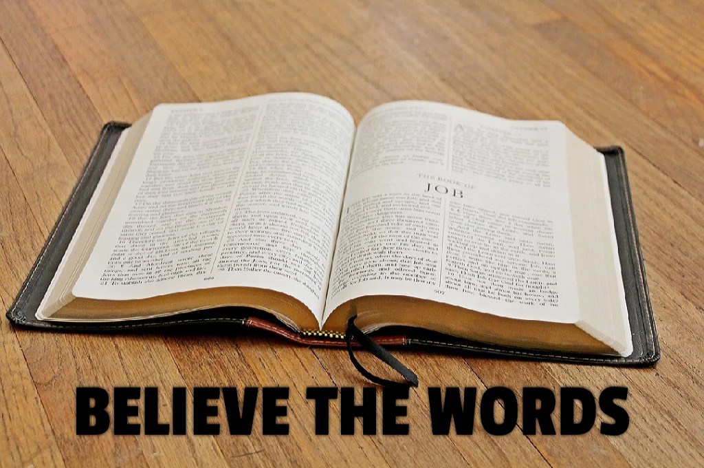 Image shows an open Bible. Text written below the Bible says believe the words.