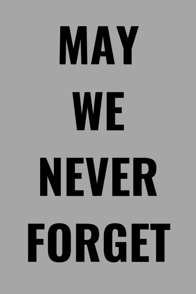 Photo description
Text is black and bold in large on a light gray background. Text reads may we never forget