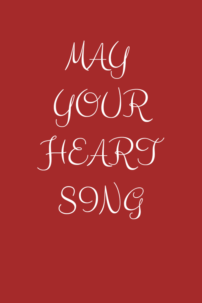 Photo description
Text reads may your heart sing. Text is white in script font on a brown background.