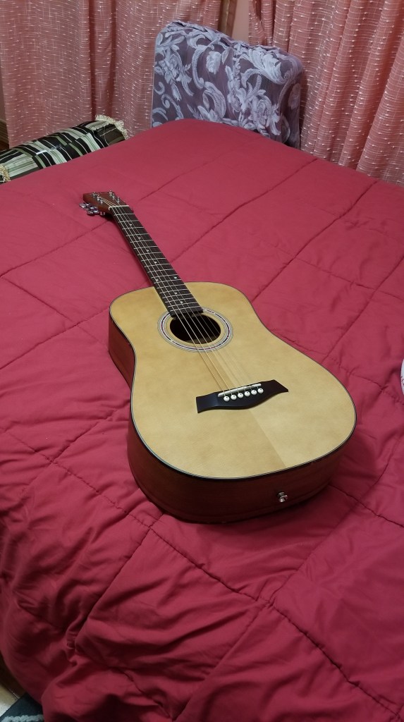 A guitar is on a bed. #hobbies #guitar 