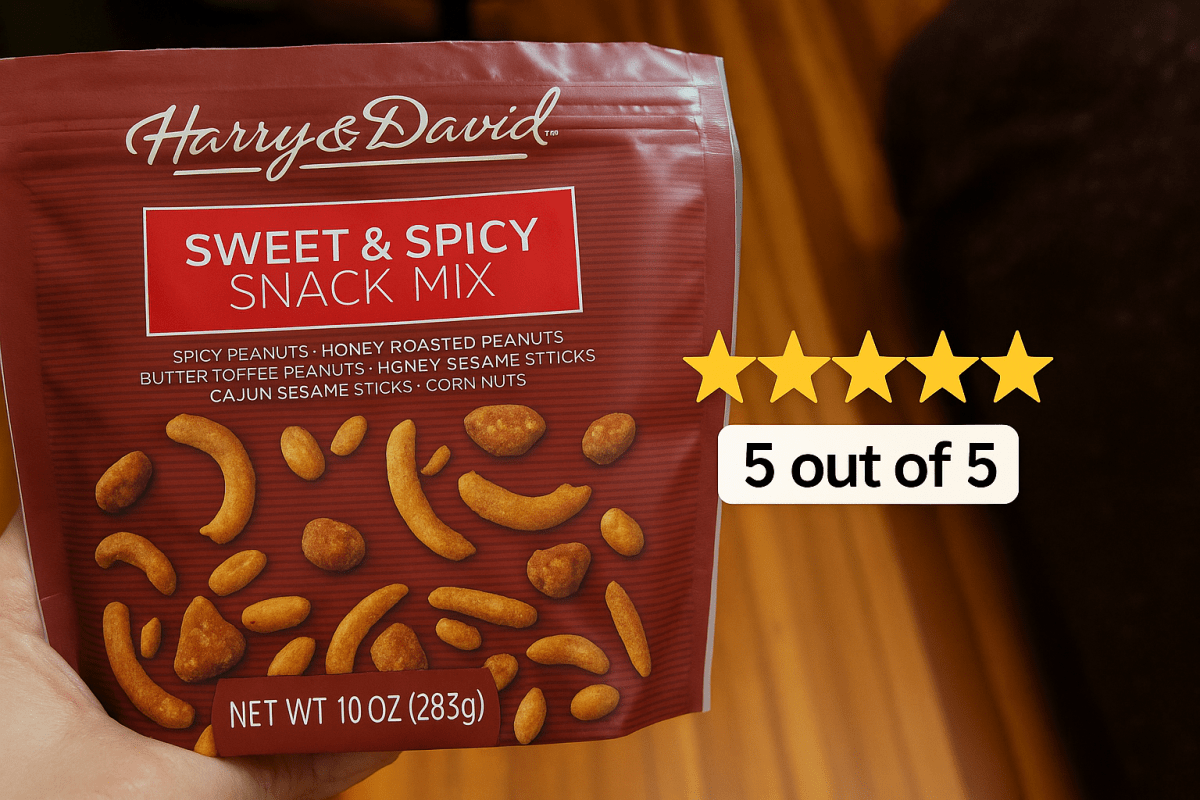 A hand holding a bag of Harry and David Sweet and Spicy Snack Mix. There is a graphic overlayed on the image of 5 yellow stars showing a 5 out of 5 rating.
